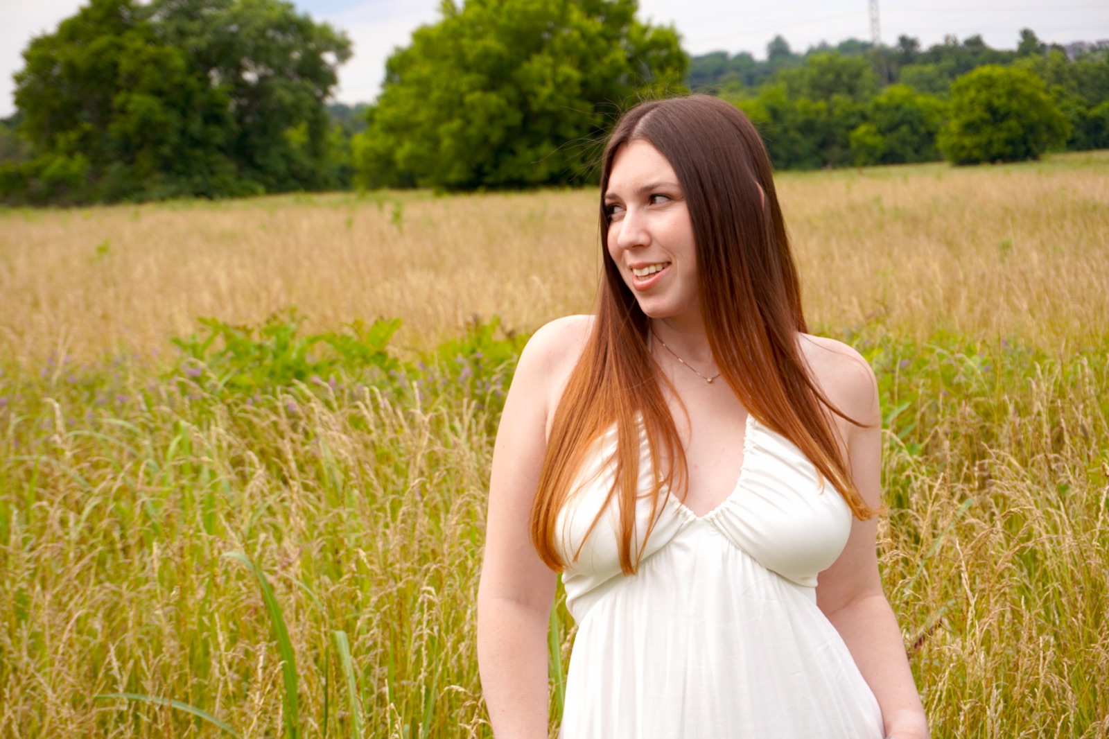Cara Paige smiling in a golden field