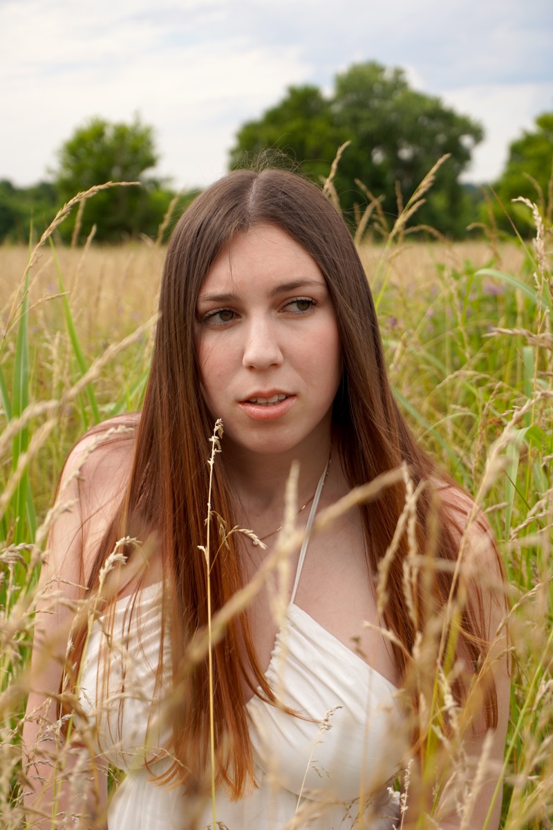 Cara Paige in a sunlit meadow